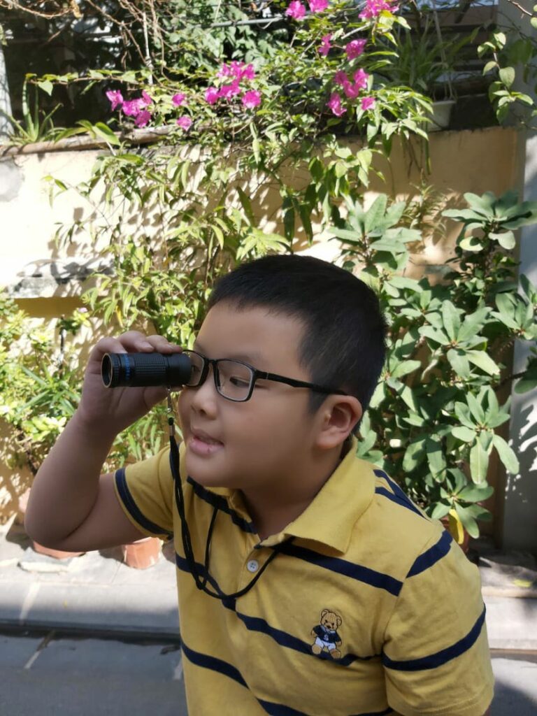 Photo of a young boy named Kiet from Vietnam with a low vision device