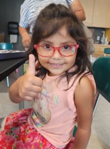 Photo of girl giving thumbs up during In Her Vision event