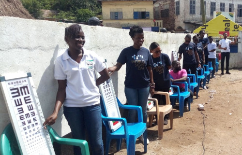 University of Cape Coast Line up of people outside testing eye sight