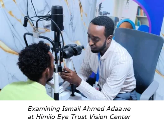 A photo of an optometrist in Somalia examining  Ismail Ahmed Adaawe<br />
at the Himilo Eye Trust Vision Center
