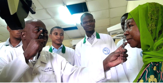 A photo of an instructor at a new School of Optometry in the developing world teaching optometry students hands-on training